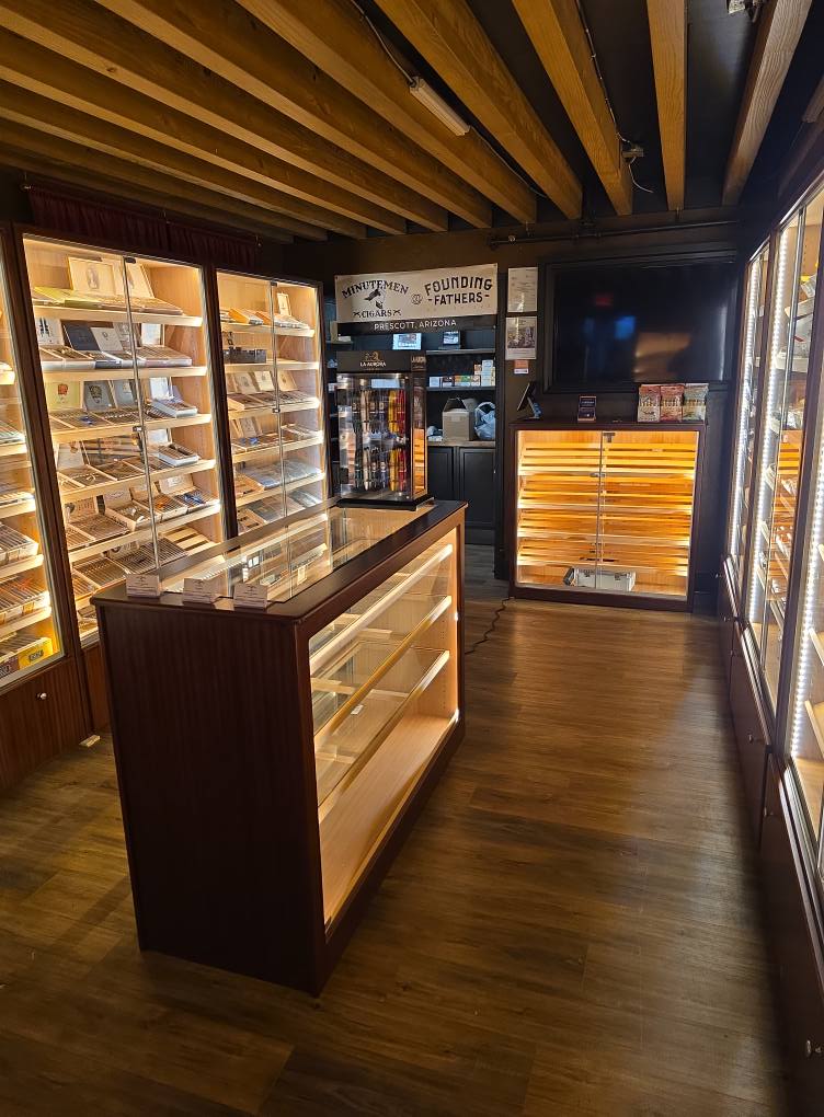 locals holding beers playing cornhole at Founding Fathers Collective Patio Area